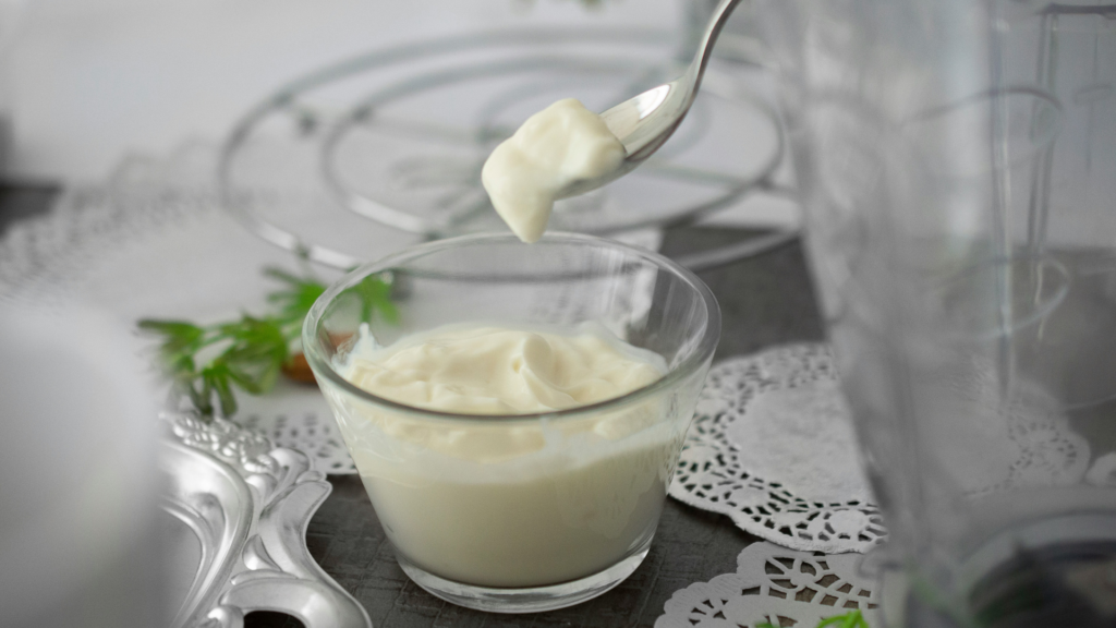 Glass Dish Of Mayonnaise With A Spoon In It