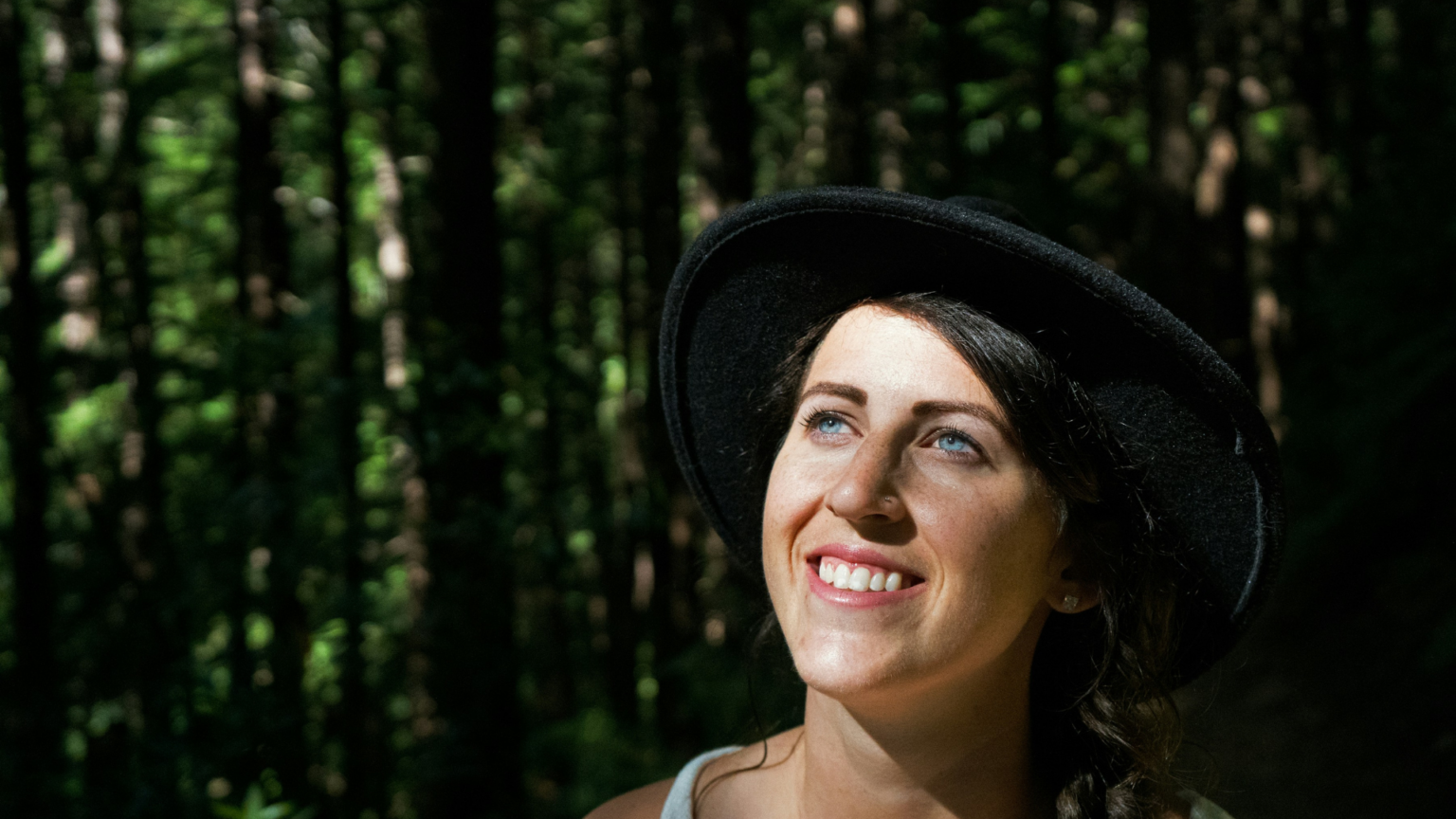 Girl Standing Outside Wearing Hat And Smiling