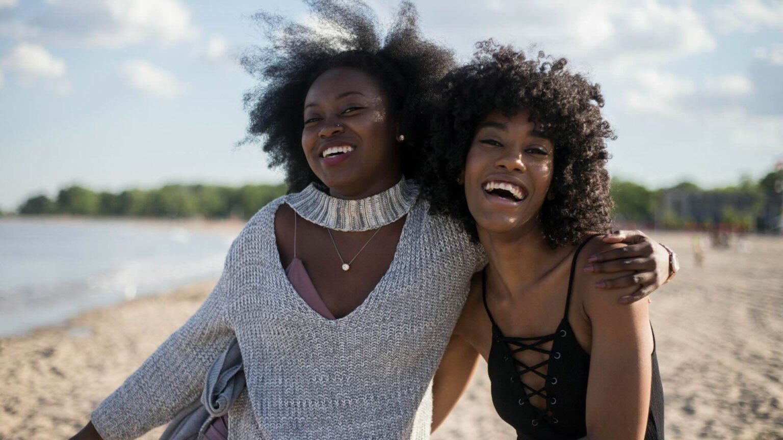 Two Women On The Beach Laughing