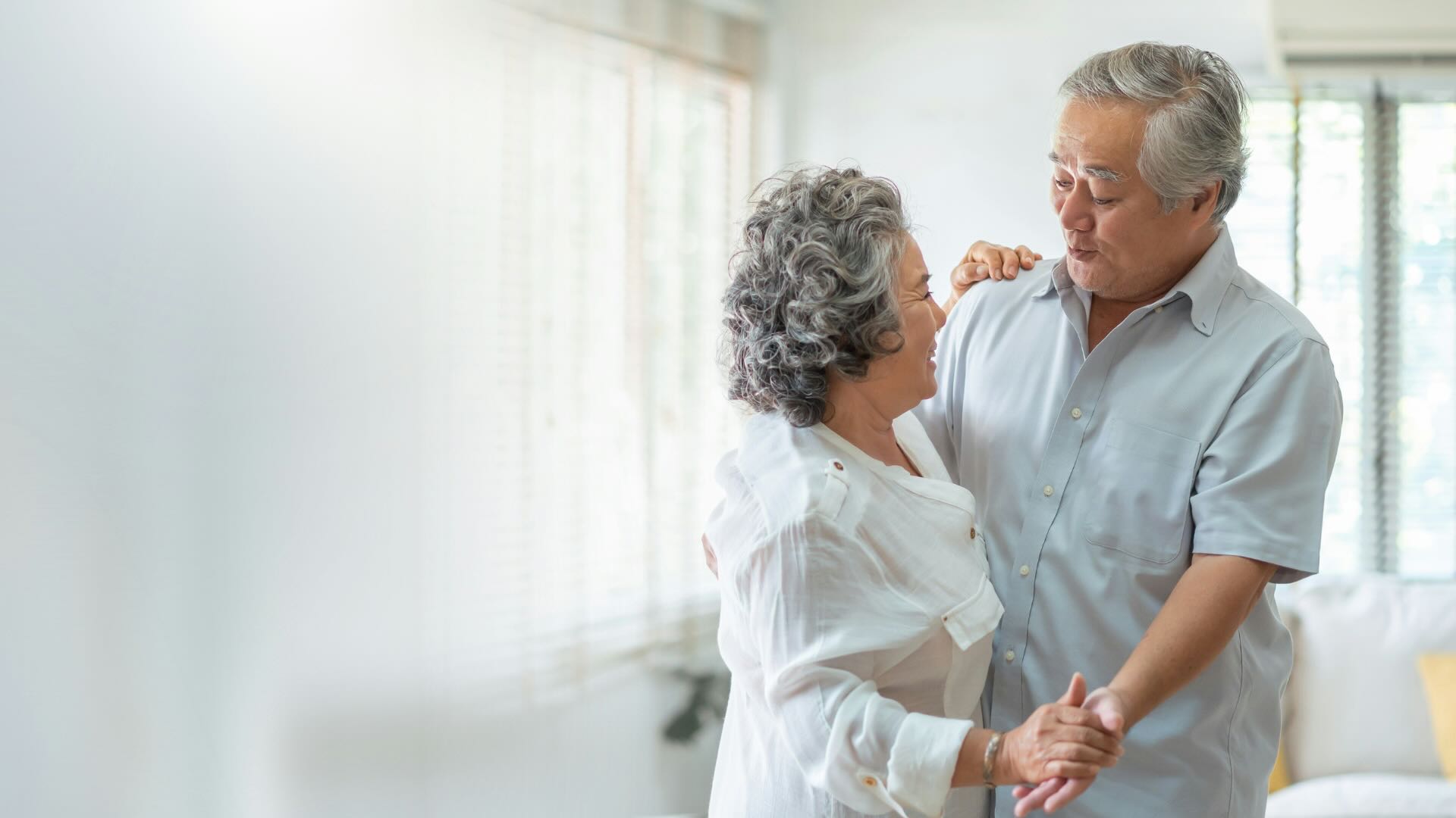 Man And Woman Dancing And Holding Hands In Room