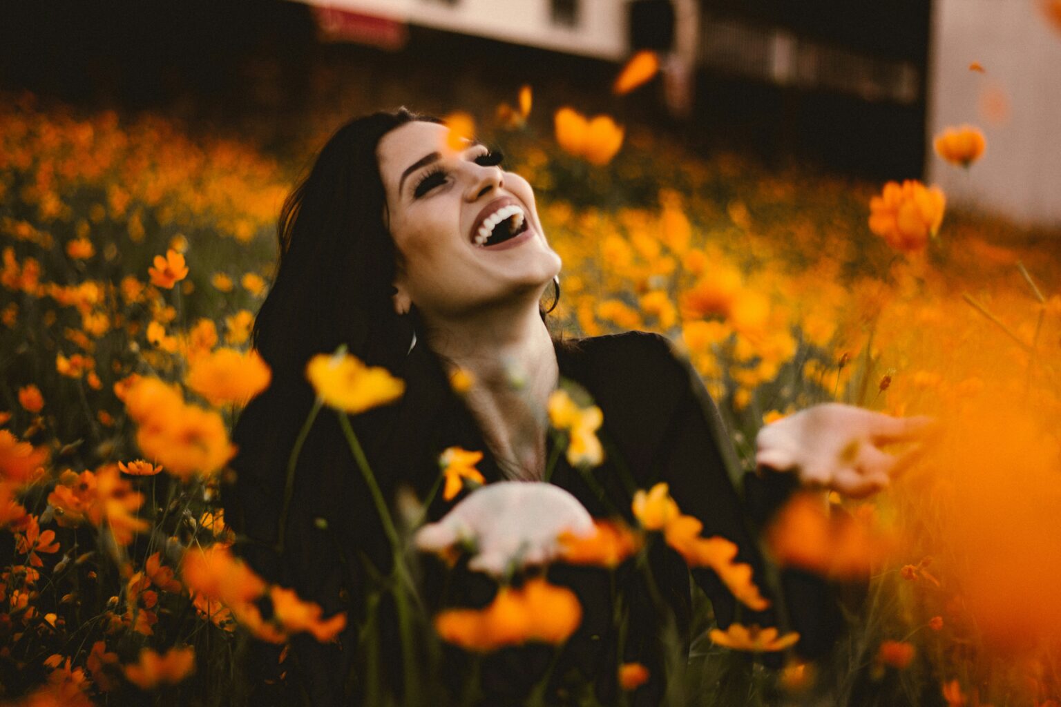 Woman Laughing In Field Of Flowers