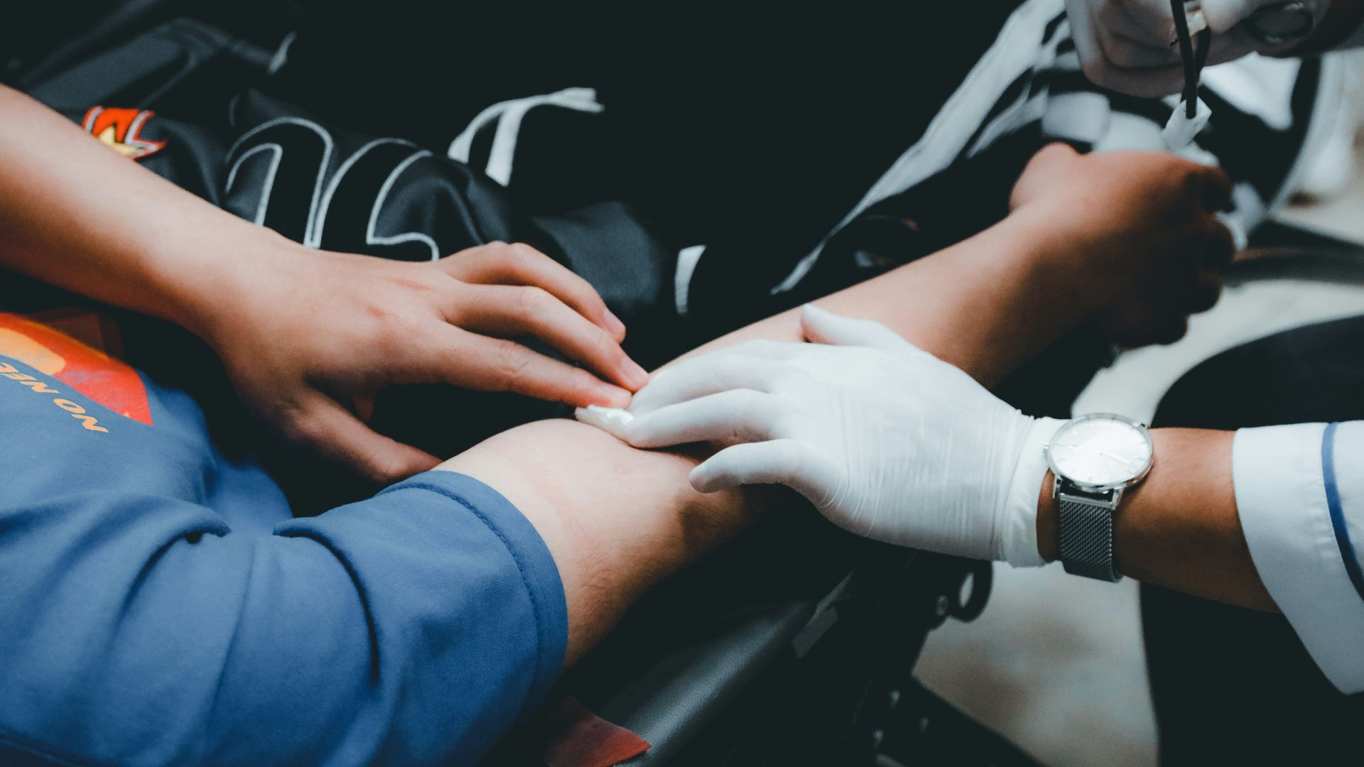 Health Professional Touching Person'S Arm To Locate Vein