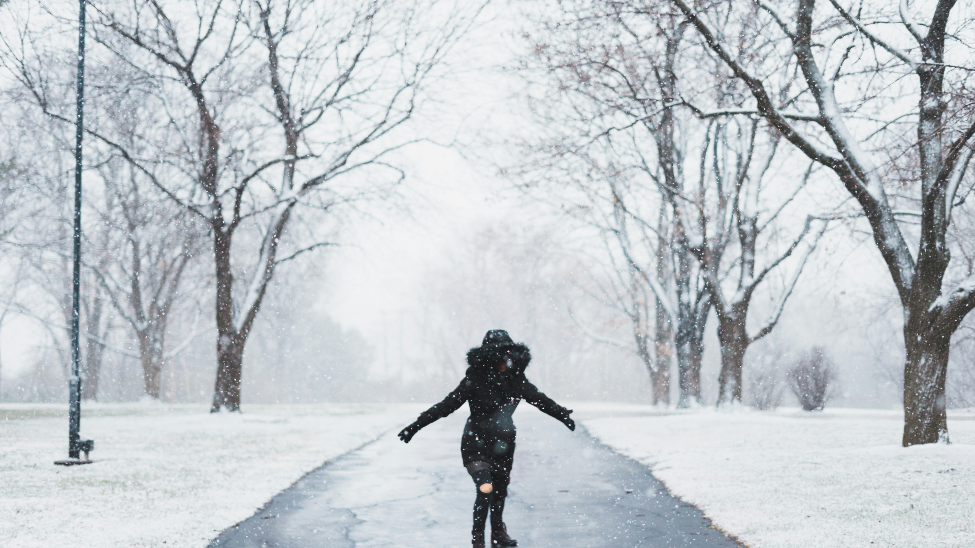 Woman On Snowy Path In Big Coat