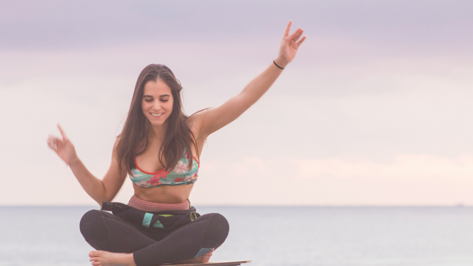 Girl Balancing On Board On Beach