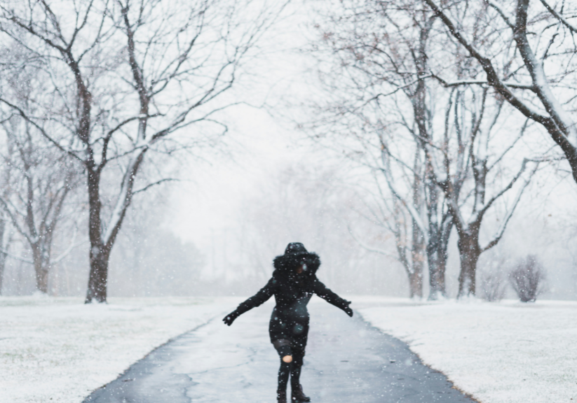 Woman On Snowy Path In Big Coat