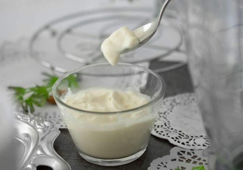 Glass Dish Of Mayonnaise With A Spoon In It