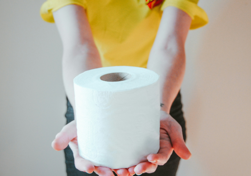 Person Holding Out Roll Of Toilet Paper