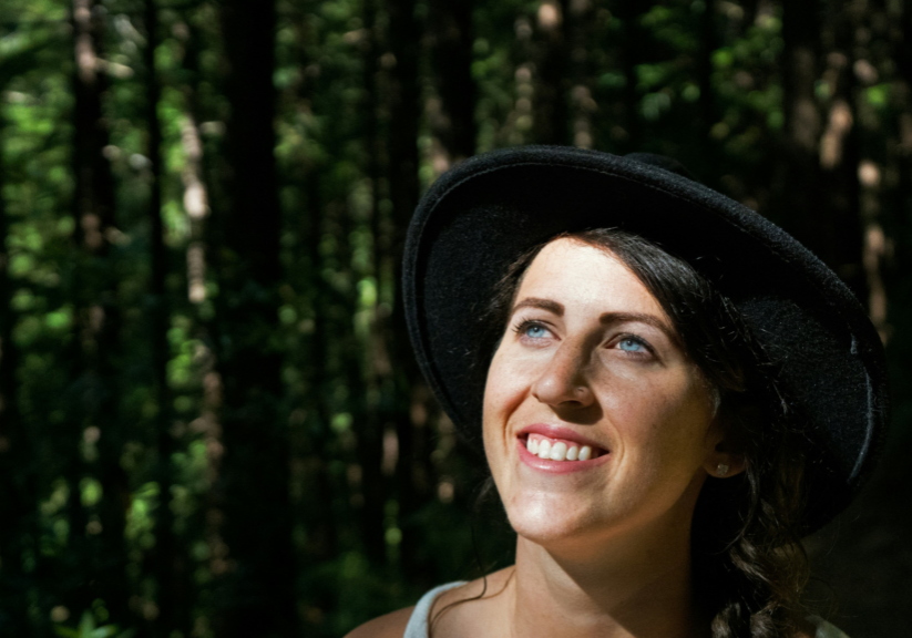 Girl Standing Outside Wearing Hat And Smiling