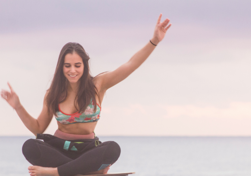 Girl Balancing On Board On Beach