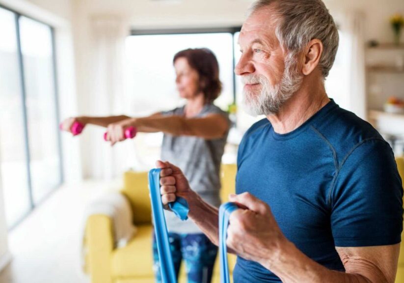 Man And Woman Exercising At Home