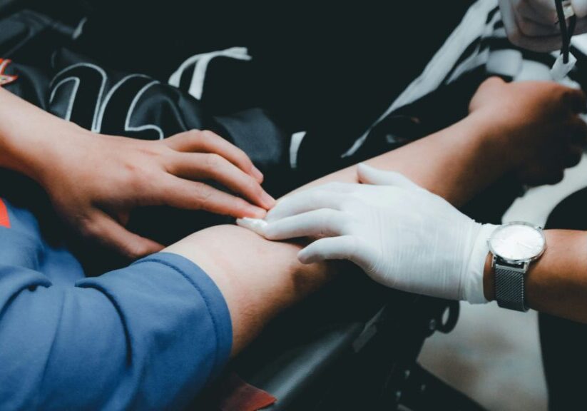 Health Professional Touching Person'S Arm To Locate Vein