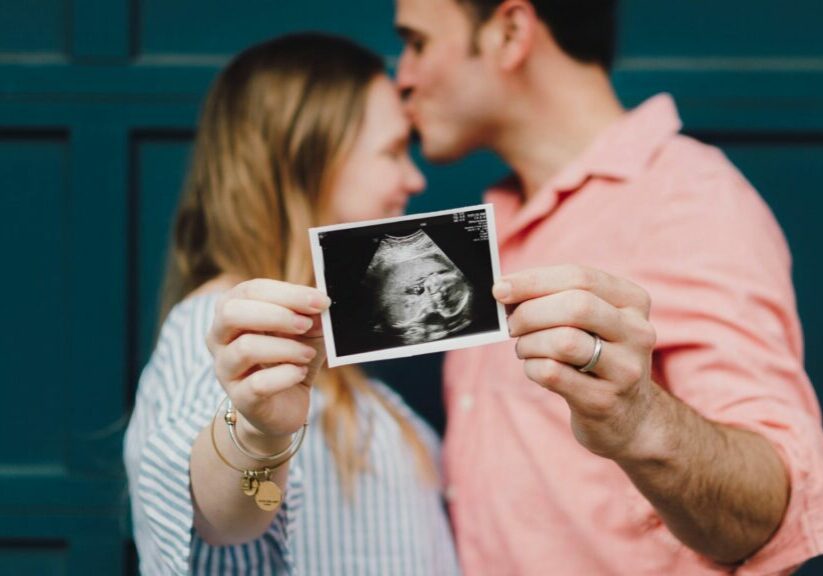 Two People Holding An Ultrasound