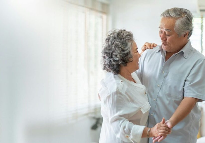 Man And Woman Dancing And Holding Hands In Room